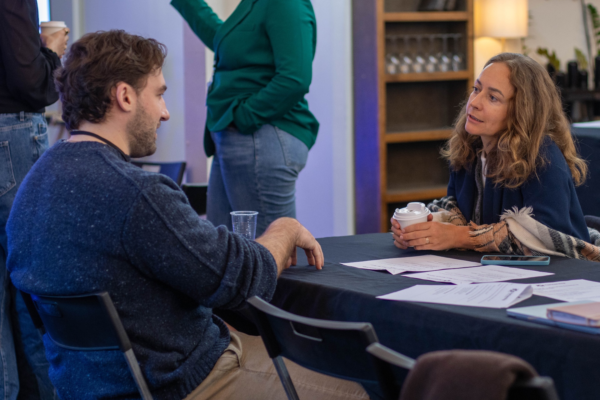 Two members in deep 1:1 conversation over coffee at the Partnership Mastermind event